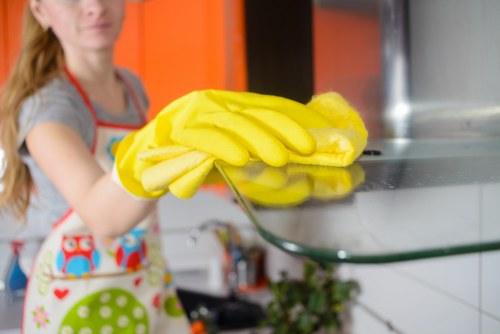 Close-up of streak-free window cleaning with squeegee and microfiber cloth