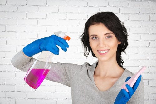 Technician using upholstery cleaning equipment on a chair